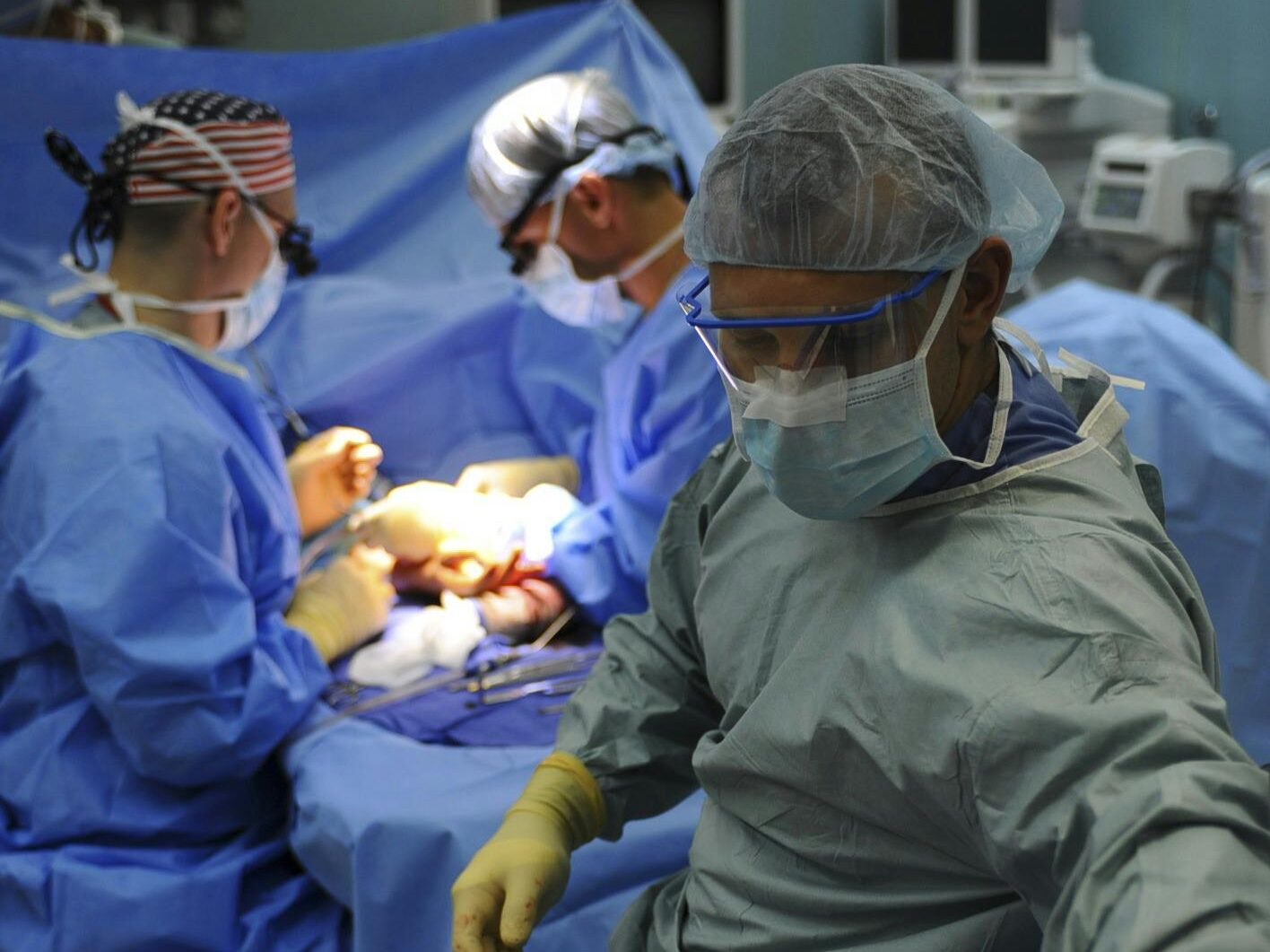 pexels-photo-263337-263337 Team of surgeons in a hospital operating room conducting a surgery.